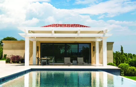 Cellular PVC Pergola on back patio overlooking the in-ground pool