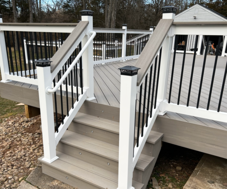 PVC Railings with Black Round Baluster and Top Rail Deck Board Deck Over Railing. The Top Rail matches the deck board used on deck.